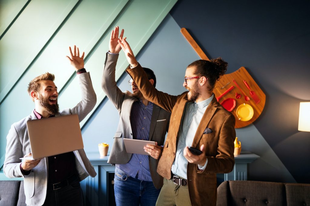 Happy successful business man giving a high fives gesture as cheer their success